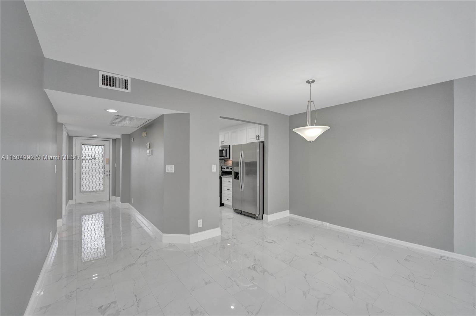 1802 Eleuthera Point, Unit E3 Coconut Creek, FL 33066 - Photo 19 of 78 a view of a livingroom with a chandelier fan and windows