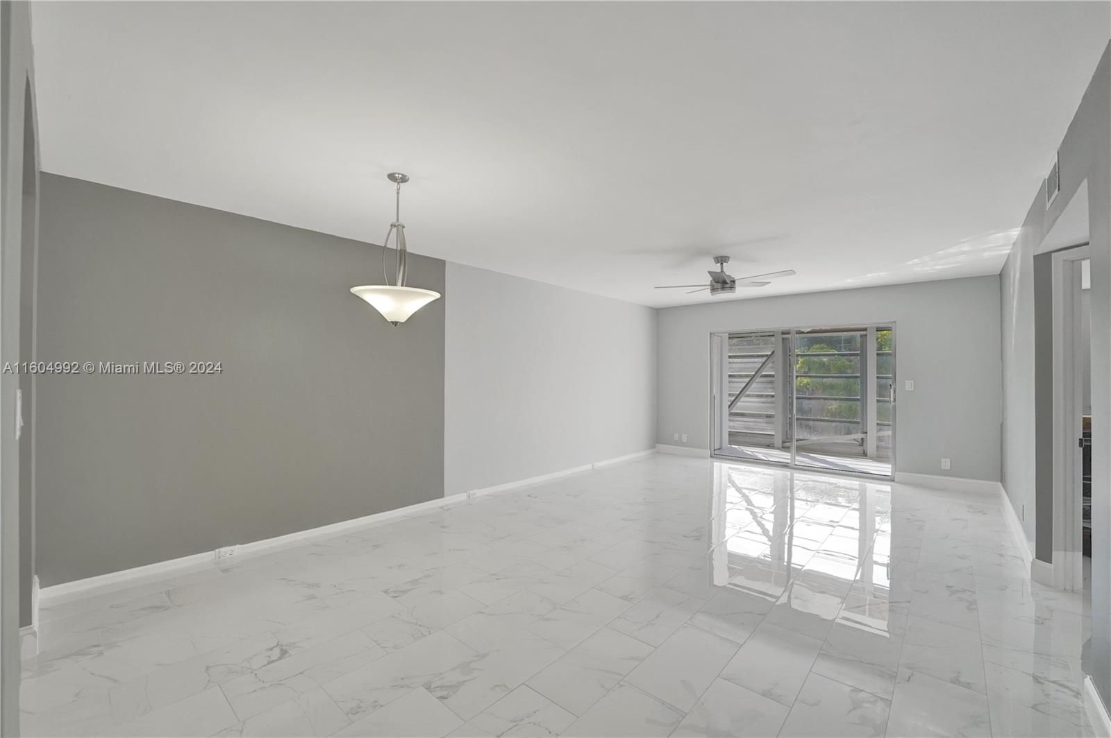 1802 Eleuthera Point, Unit E3 Coconut Creek, FL 33066 - Photo 22 of 78 an empty room with windows and entrance