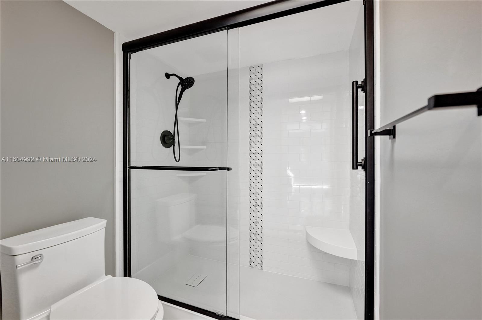 1802 Eleuthera Point, Unit E3 Coconut Creek, FL 33066 - Photo 30 of 78 a bathroom with a glass shower door