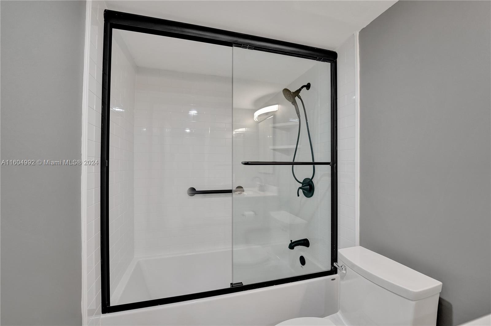 1802 Eleuthera Point, Unit E3 Coconut Creek, FL 33066 - Photo 38 of 78 a bathroom with a glass shower door