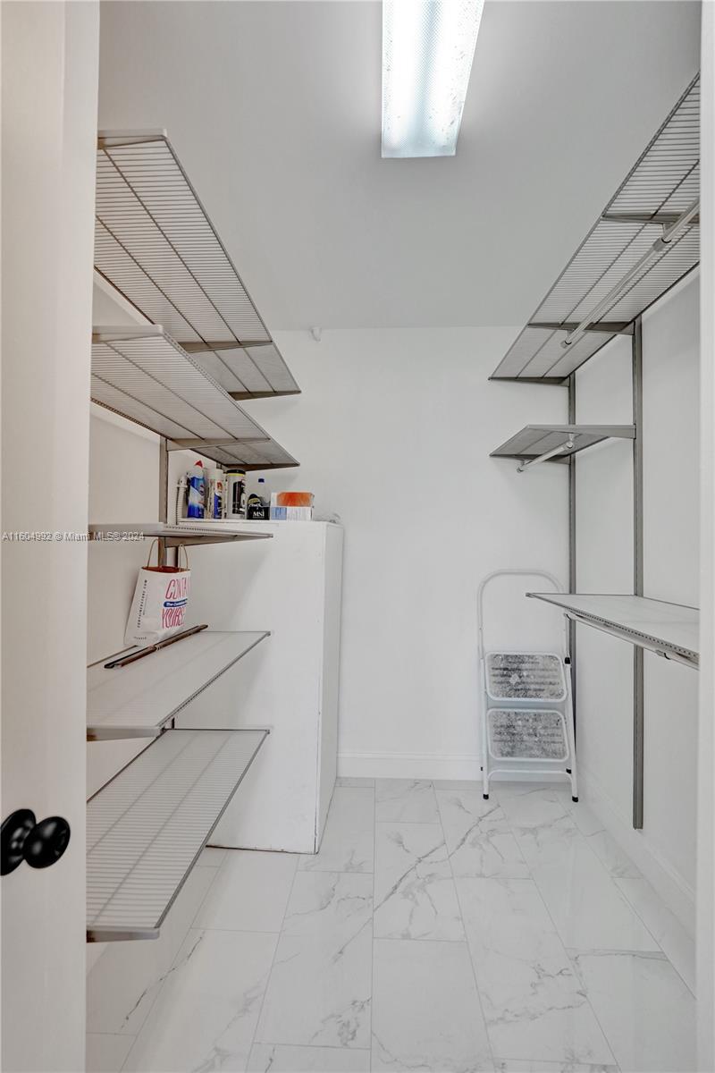 1802 Eleuthera Point, Unit E3 Coconut Creek, FL 33066 - Photo 39 of 78 a storage room with cabinets
