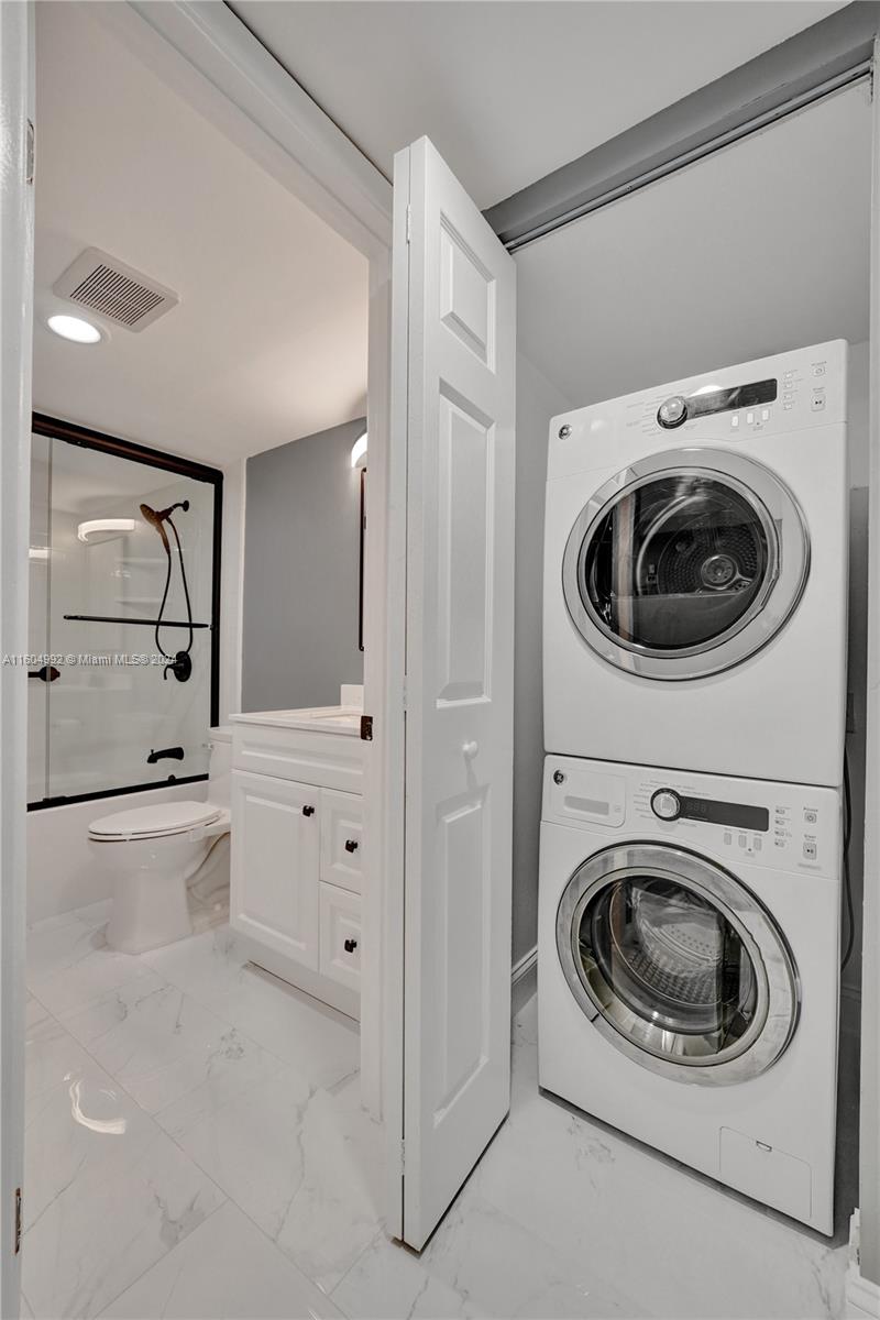 1802 Eleuthera Point, Unit E3 Coconut Creek, FL 33066 - Photo 40 of 78 a utility room with sink dryer and washer
