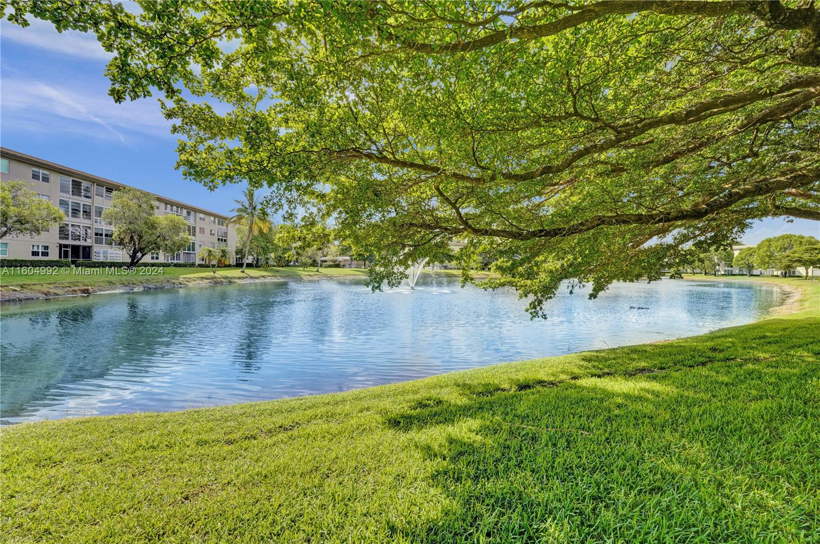 1802 Eleuthera Point, Unit E3 Coconut Creek, FL 33066 - Photo 44 of 78 a view of a lake with a building in the background