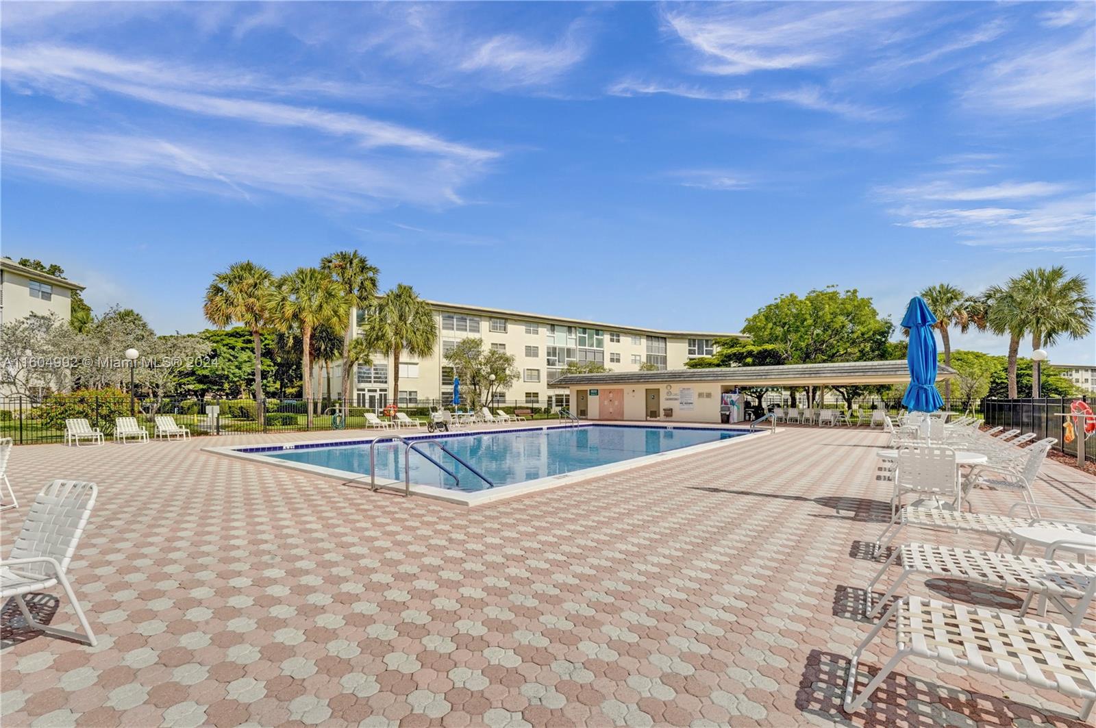 1802 Eleuthera Point, Unit E3 Coconut Creek, FL 33066 - Photo 59 of 78 a view of a swimming pool with an outdoor seating