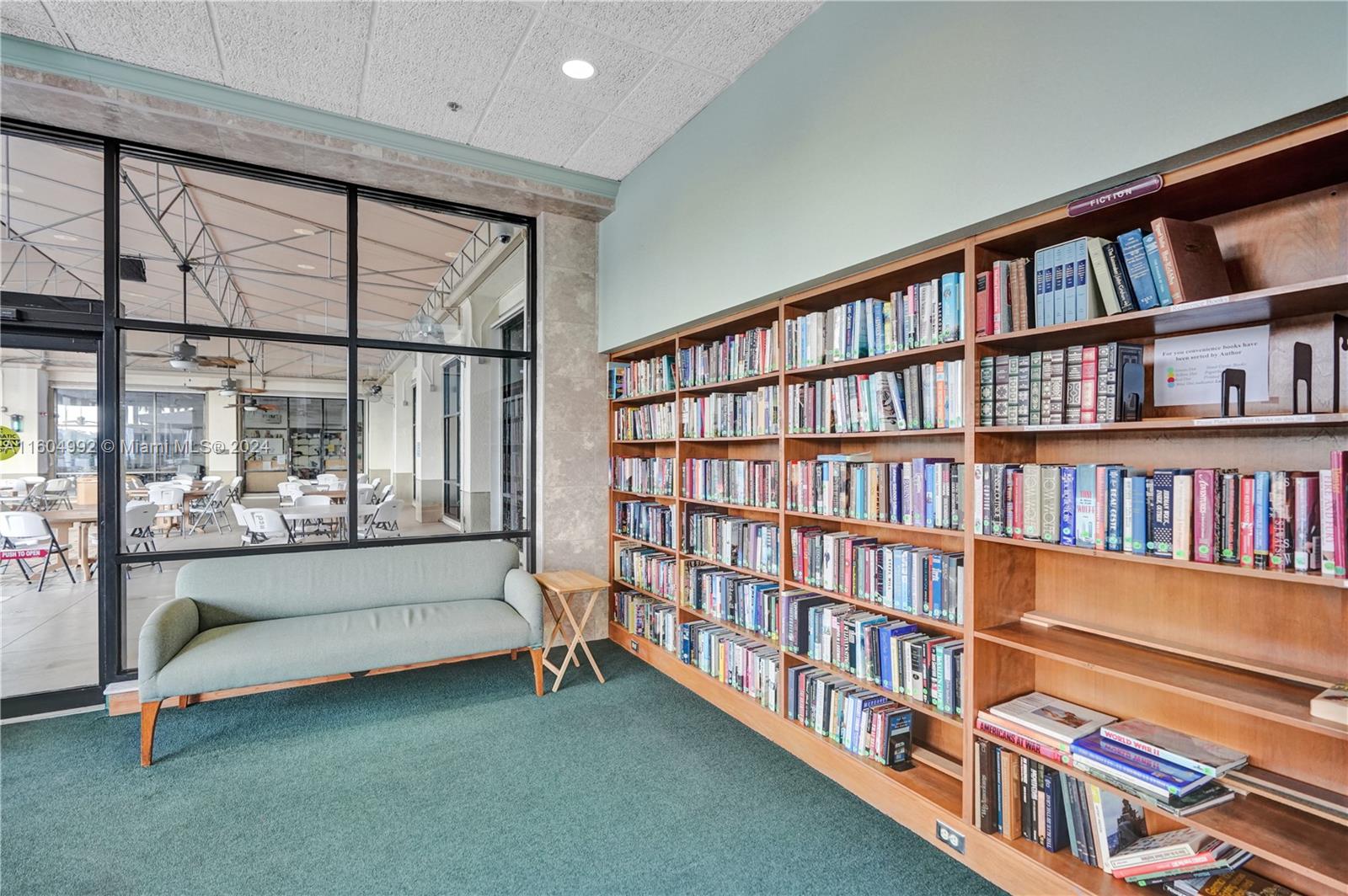 1802 Eleuthera Point, Unit E3 Coconut Creek, FL 33066 - Photo 62 of 78 a living room with large couches and a book shelf