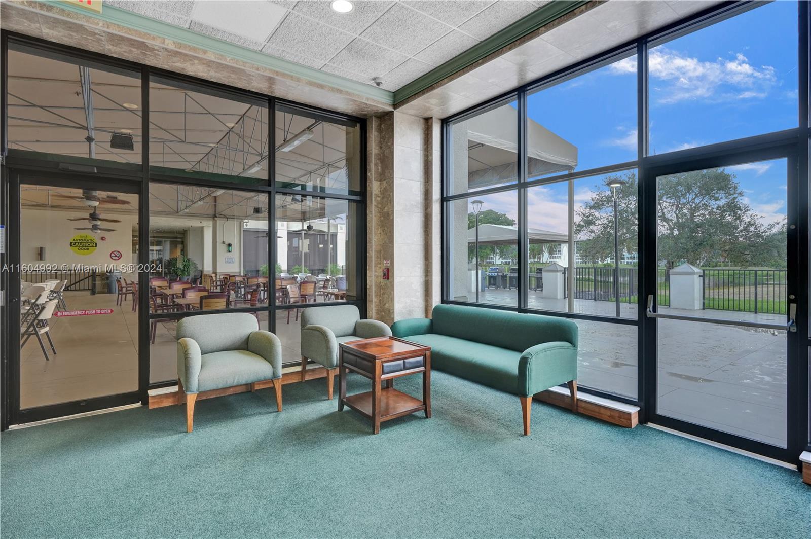 1802 Eleuthera Point, Unit E3 Coconut Creek, FL 33066 - Photo 63 of 78 a living room with furniture and a large window