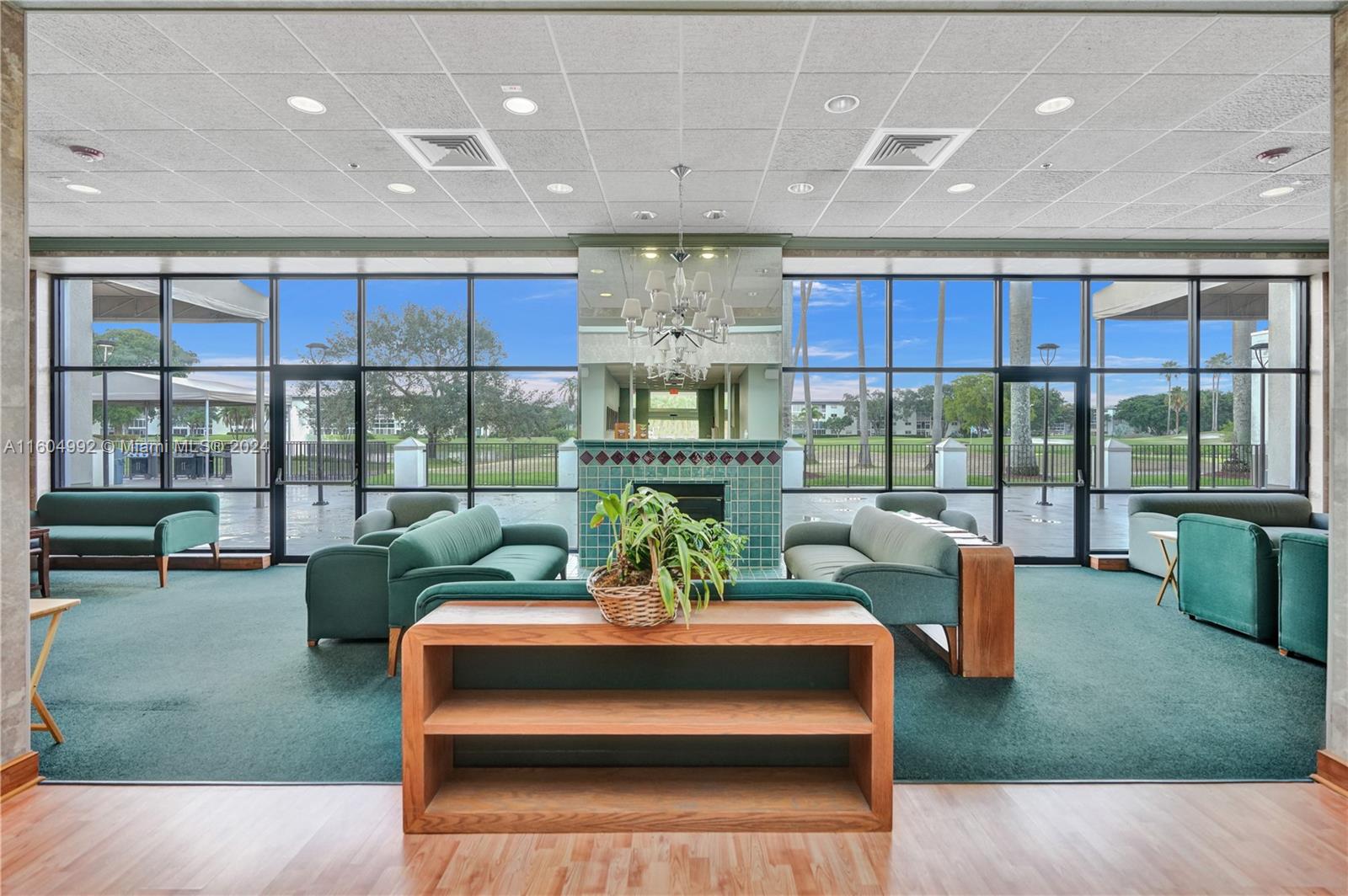 1802 Eleuthera Point, Unit E3 Coconut Creek, FL 33066 - Photo 64 of 78 a living room with fireplace furniture and a floor to ceiling window