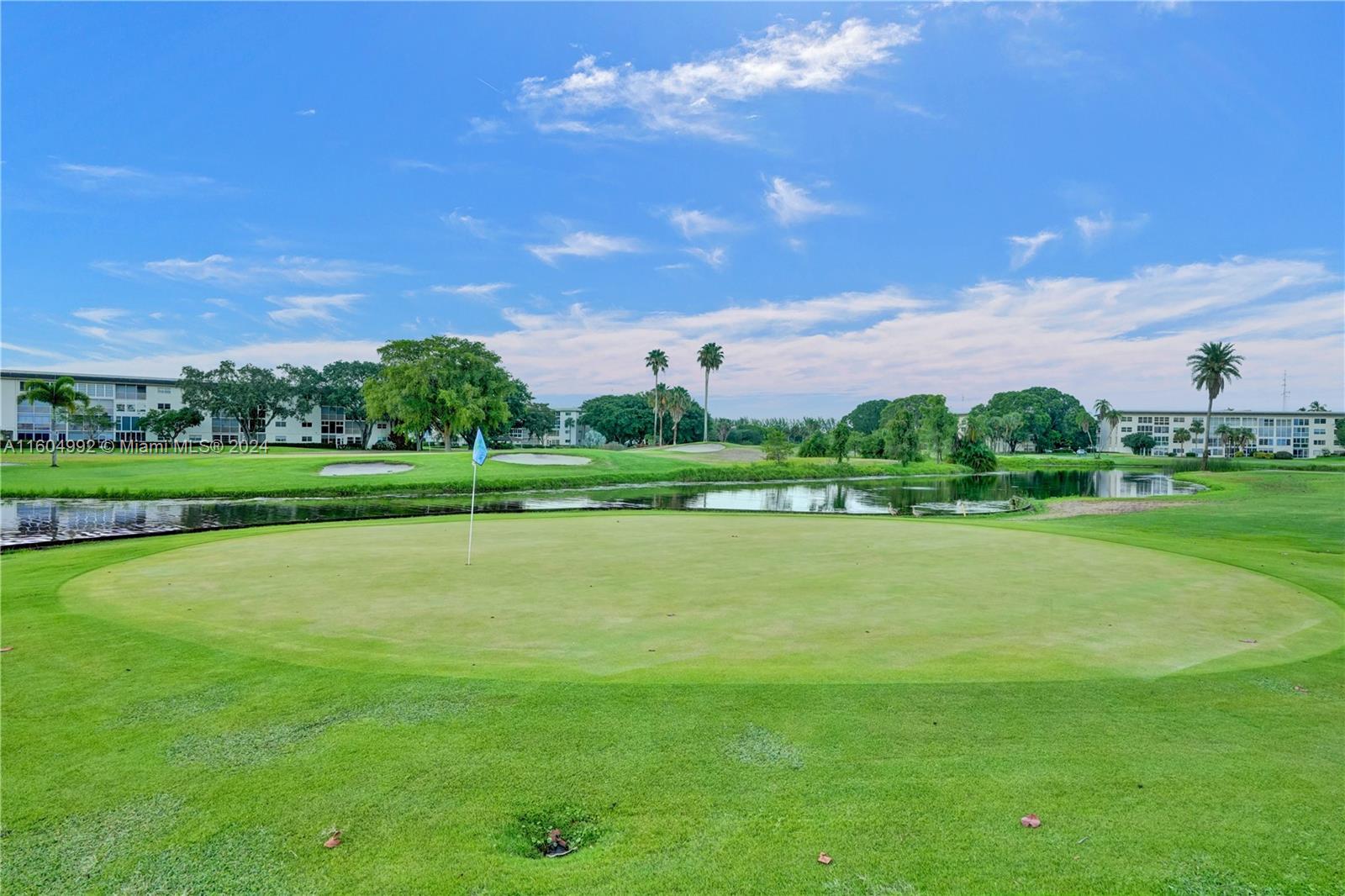 1802 Eleuthera Point, Unit E3 Coconut Creek, FL 33066 - Photo 67 of 78 a view of a golf course with a lake view
