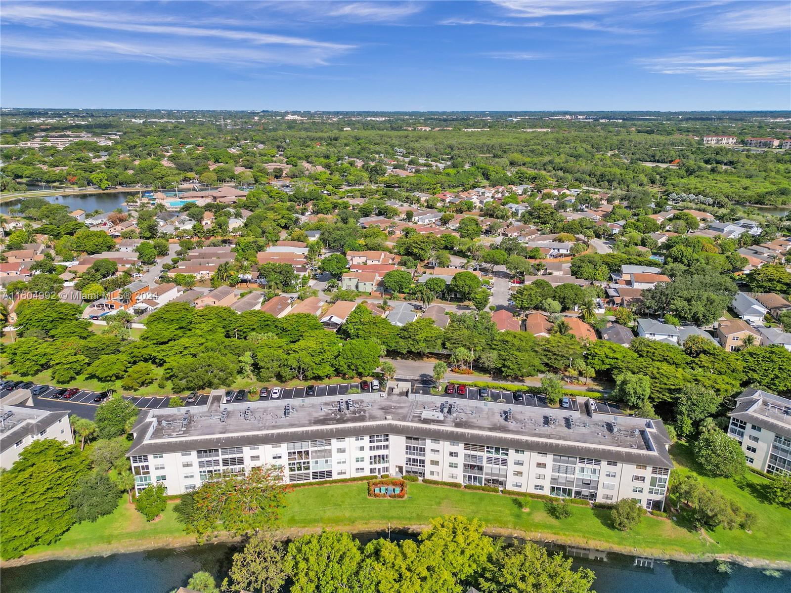 1802 Eleuthera Point, Unit E3 Coconut Creek, FL 33066 - Photo 78 of 78 a view of a large pool with lawn chairs and wooden fence