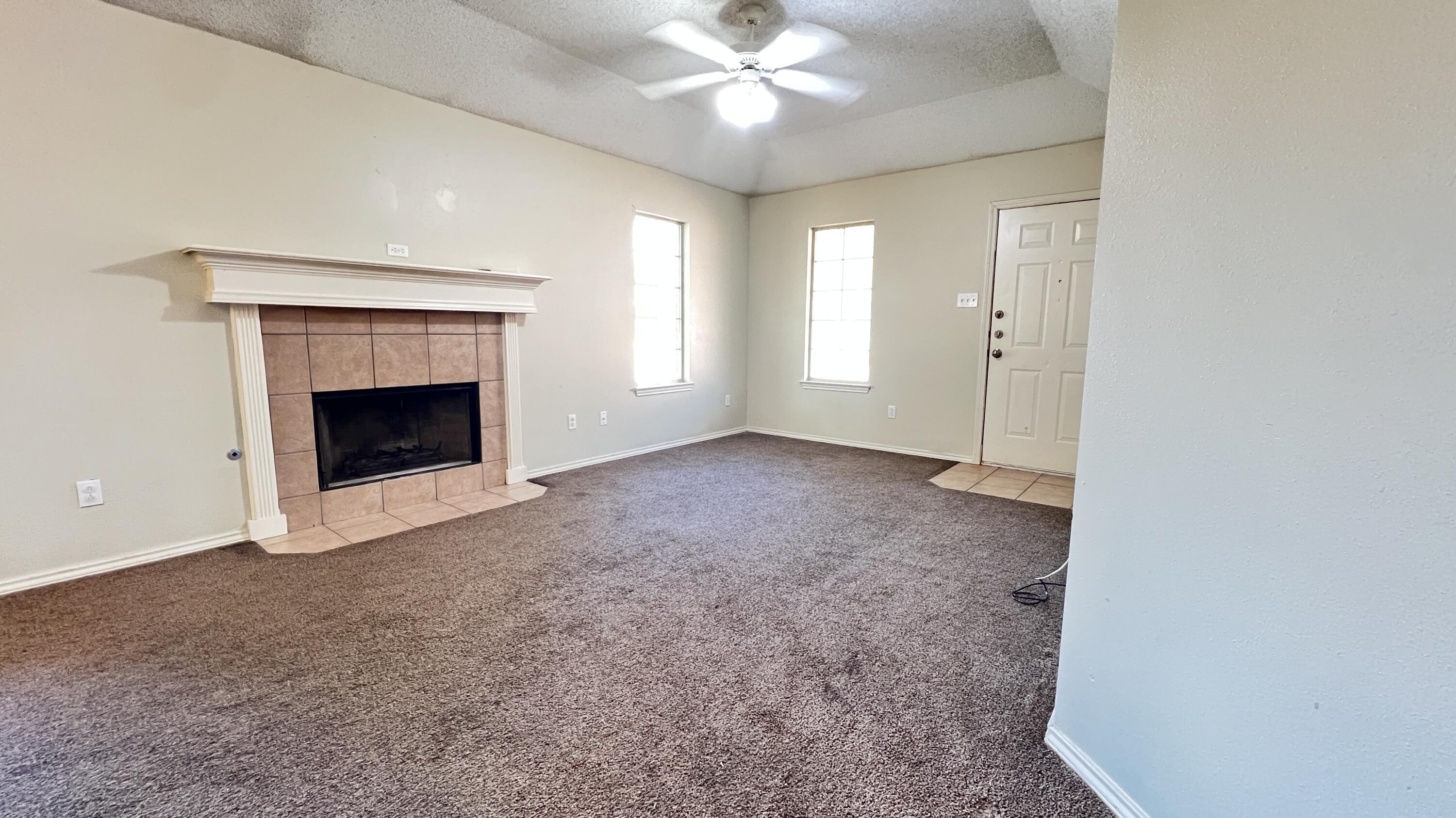 3102 110th Street Lubbock, TX 79423 - Photo 3 of 11 an empty room with fan and windows