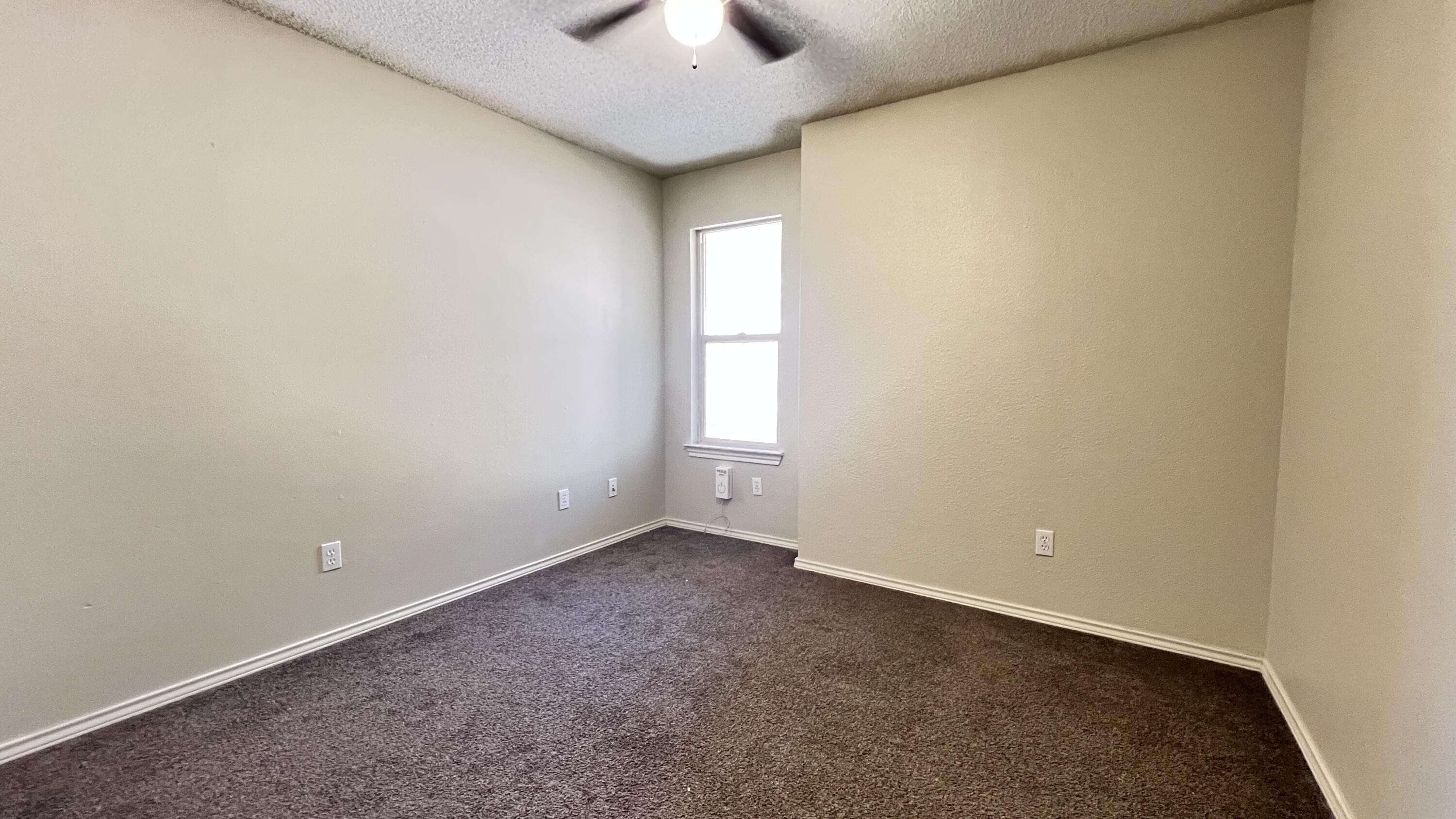 3102 110th Street Lubbock, TX 79423 - Photo 7 of 11 a view of an empty room and a window
