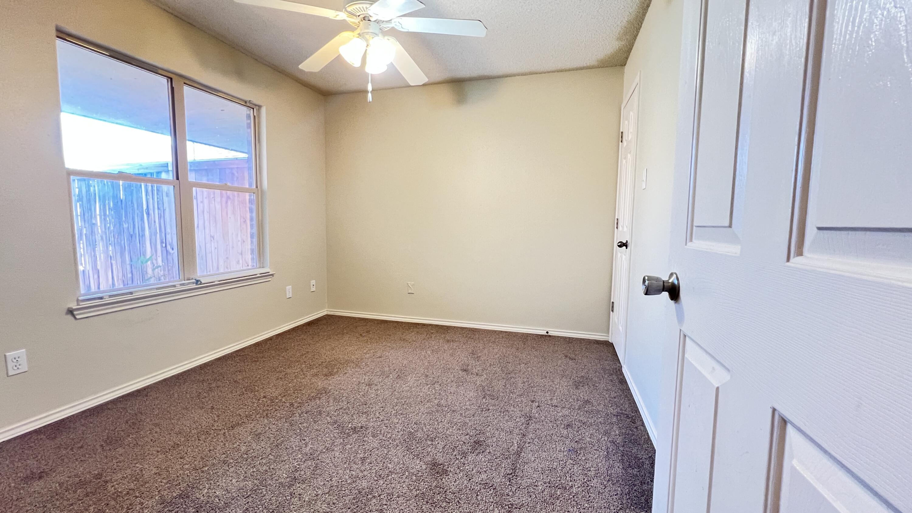 3102 110th Street Lubbock, TX 79423 - Photo 8 of 11 a view of an empty room with a window