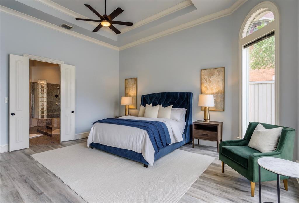 5212 Scottish Way Plano, TX 75093 - Photo 2 of 4 a bedroom with a bed and a chandelier