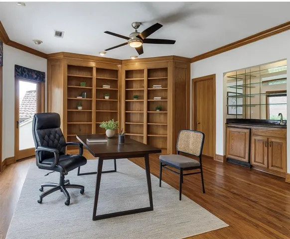 a view of a workspace with furniture and a window