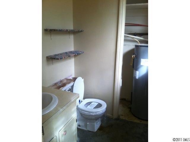 4104 Sterling Road Gastonia, NC 28056 - Photo 5 of 9 a white toilet sitting next to a bathroom sink and vanity