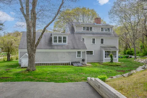 a view of a house with a yard porch and sitting area