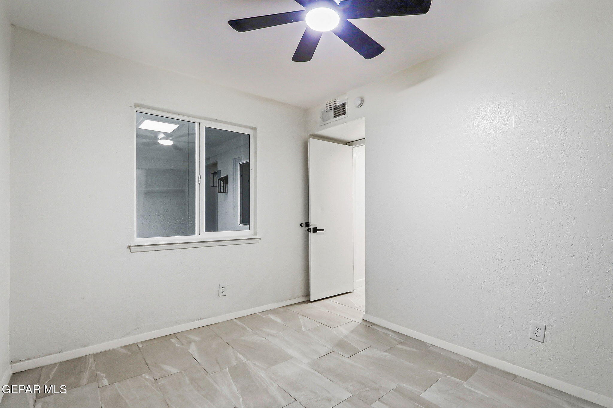709 Frontera Road El Paso, TX 79922 - Photo 26 of 41 an empty room with windows and fan