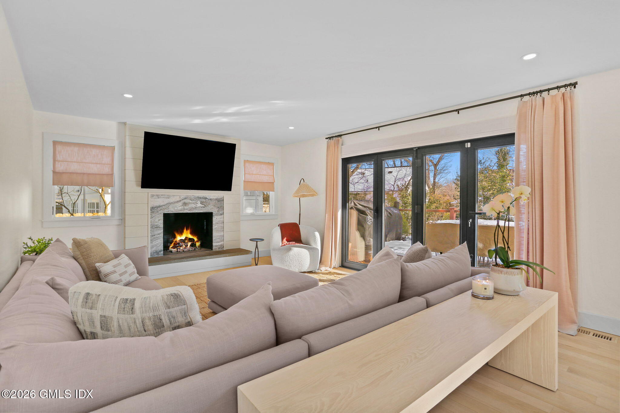 10 Lockwood Road Riverside, CT 06878 - Photo 14 of 38 a living room with furniture a flat screen tv and a fireplace