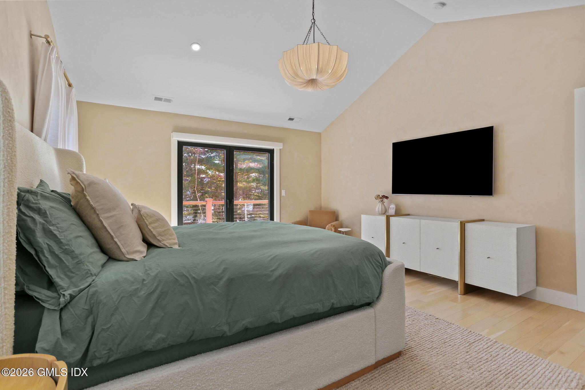 10 Lockwood Road Riverside, CT 06878 - Photo 20 of 38 a bedroom with a large bed and a flat tv screen on dresser