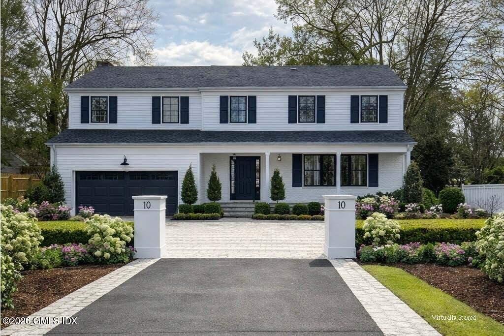 10 Lockwood Road Riverside, CT 06878 - Photo 2 of 38 a front view of a house with a yard and garage