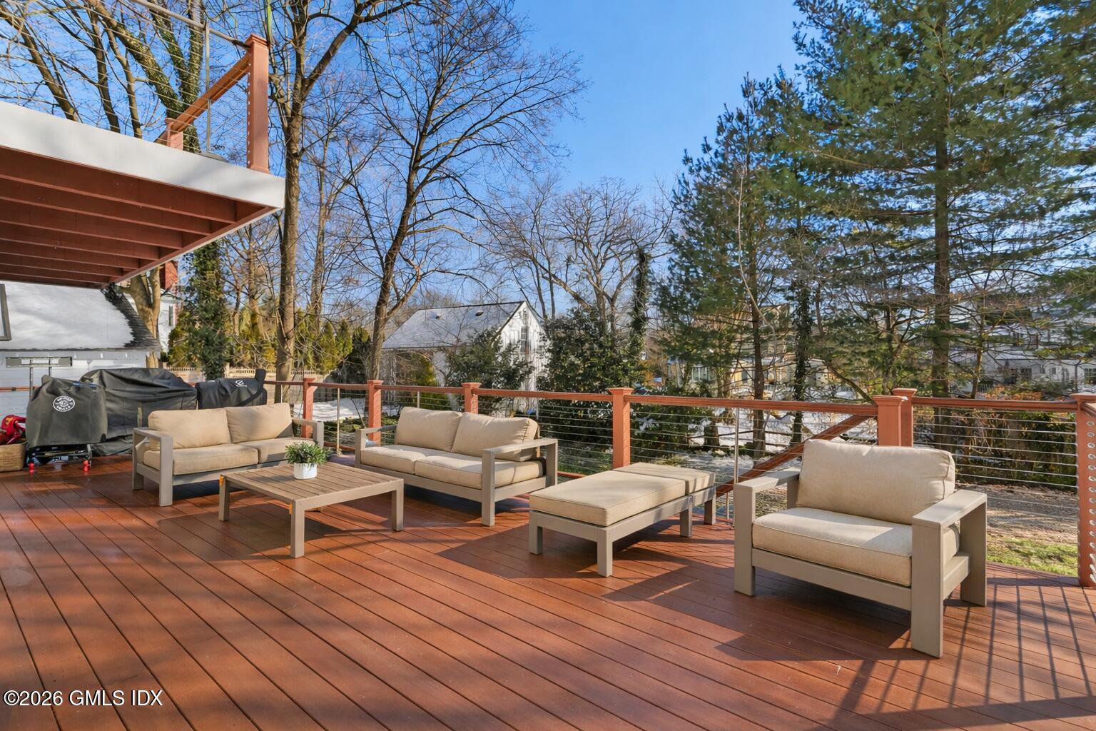 10 Lockwood Road Riverside, CT 06878 - Photo 37 of 38 a view of a patio with couches and table and chairs with wooden floor and fence