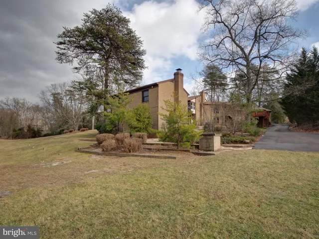 a view of a house with a yard and tree s