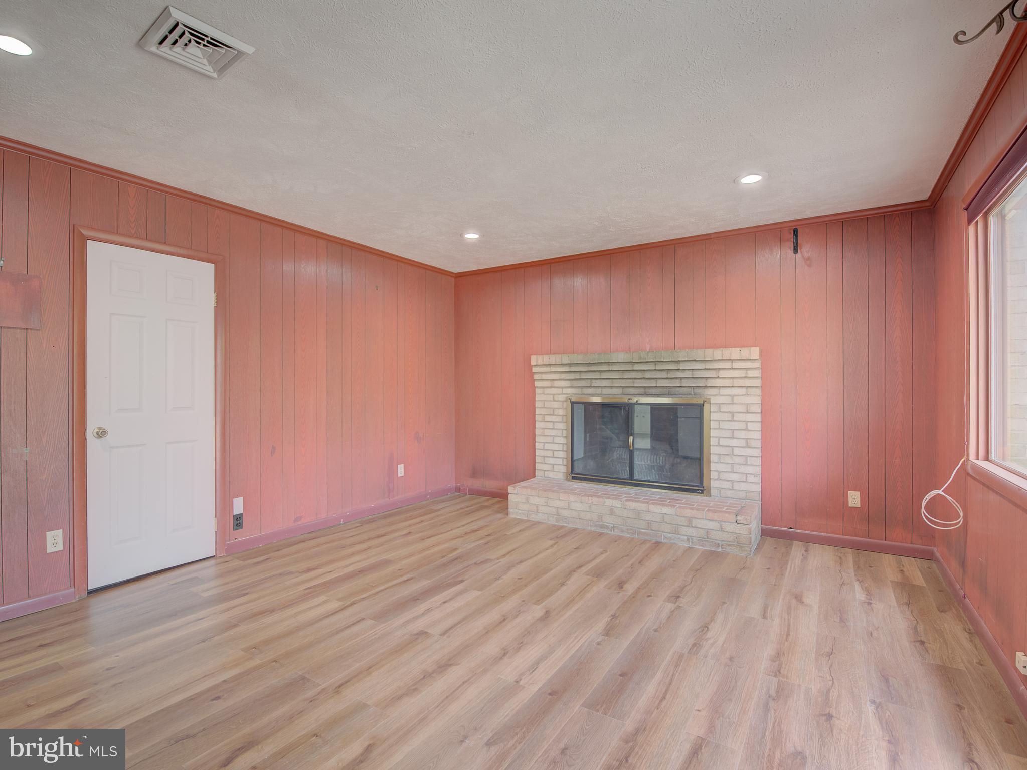 1108 B Shaker Woods Road Herndon, VA 20170 - Photo 4 of 24 a view of an empty room with a fireplace and a window