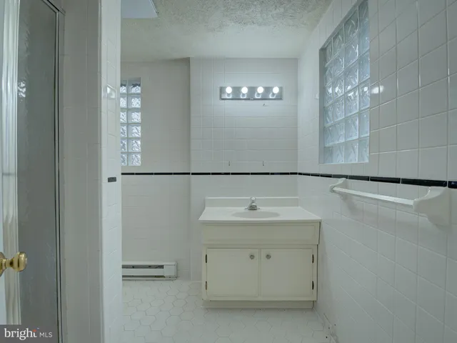 a bathroom with a glass shower door