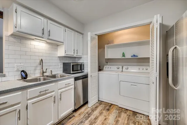 a kitchen with a sink stove and cabinets