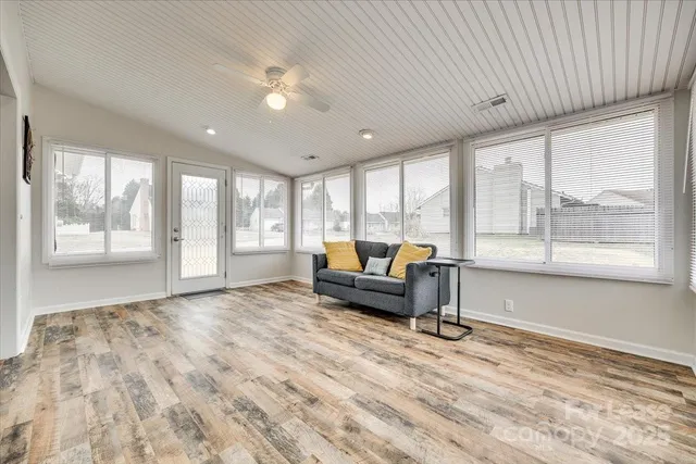 a living room with furniture and large windows