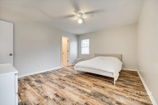 a bedroom with a large bed and a chandelier
