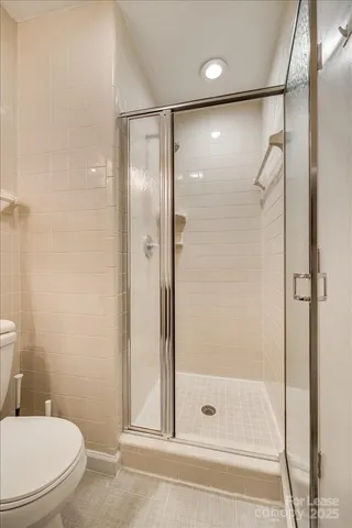 a bathroom with a glass shower door