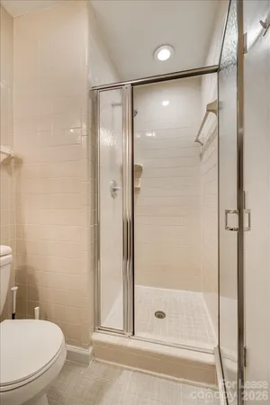 a bathroom with a glass shower door