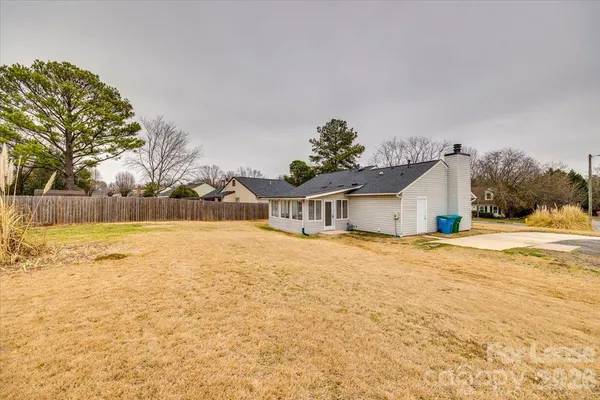 a yellow house with trees in front of it