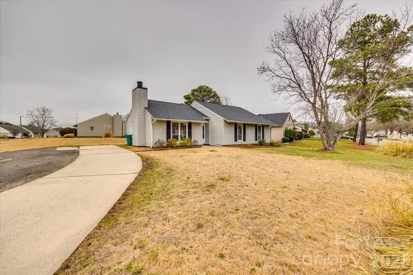a swimming pool with trees in front of it
