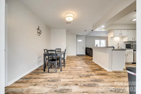 a view of a dining room with furniture and wooden floor