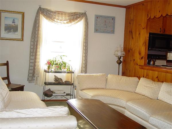 75 Glendon Road, Unit 75 Dennis, MA 02639 - Photo 13 of 22 a living room with furniture and a flat screen tv