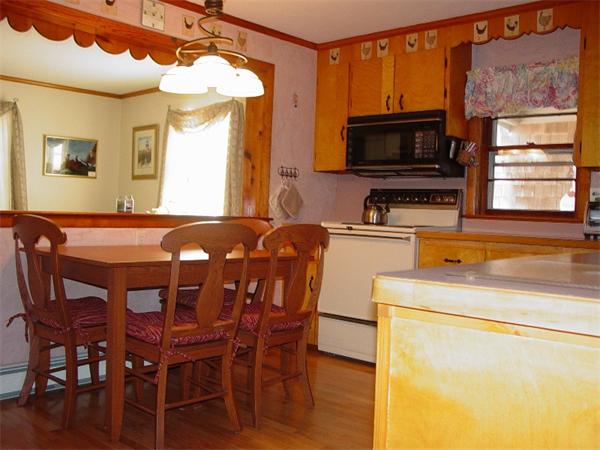 75 Glendon Road, Unit 75 Dennis, MA 02639 - Photo 4 of 22 a dining room with a wooden table and chairs