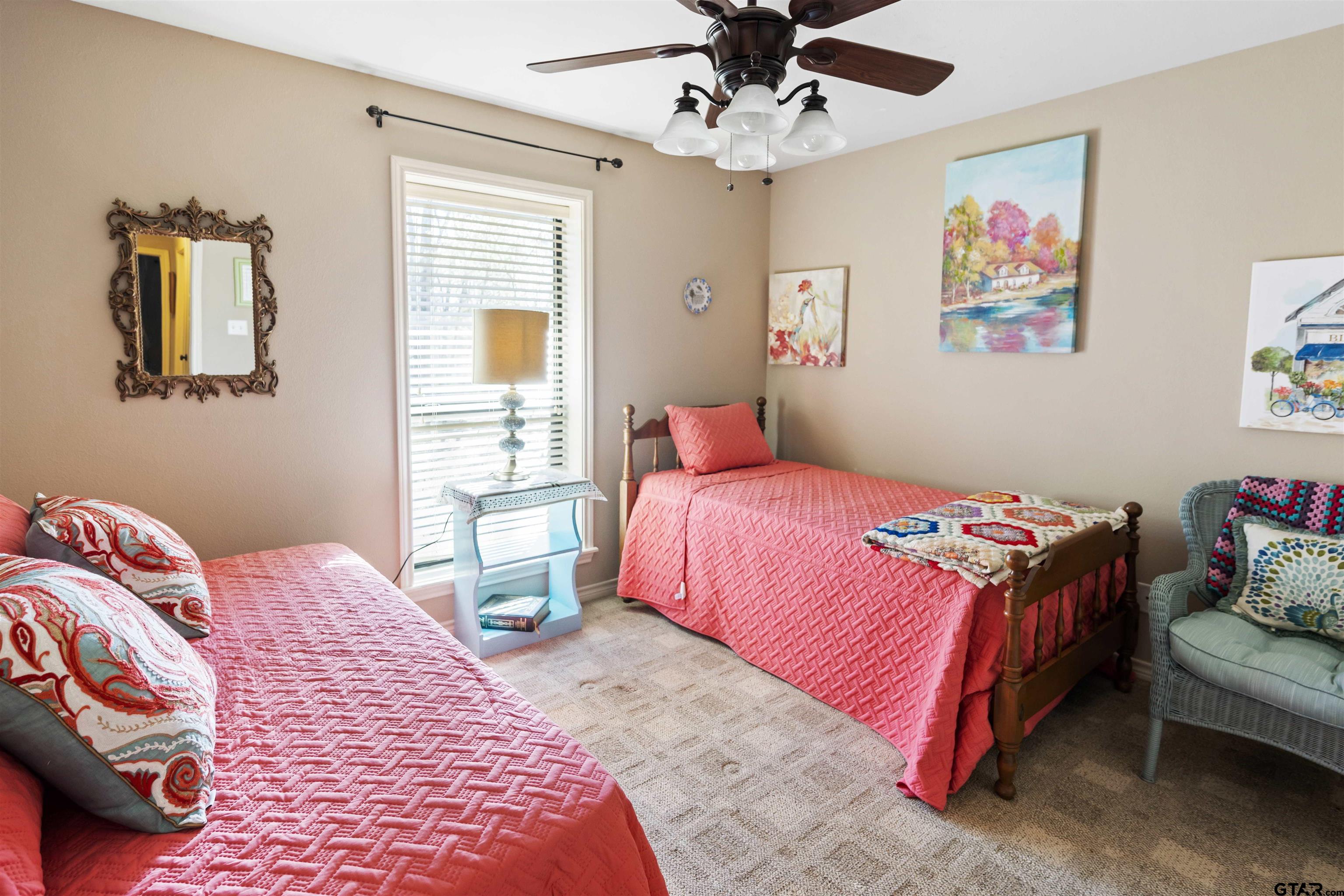 175 Old Gate Path Holly Lake Ranch, TX 75755 - Photo 18 of 28 a bedroom with three beds and a chandelier