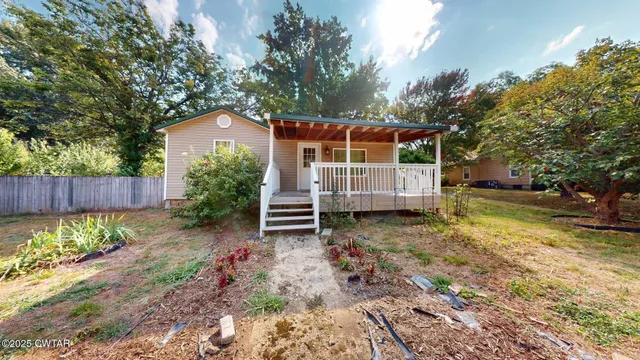 a view of a wooden house with a yard