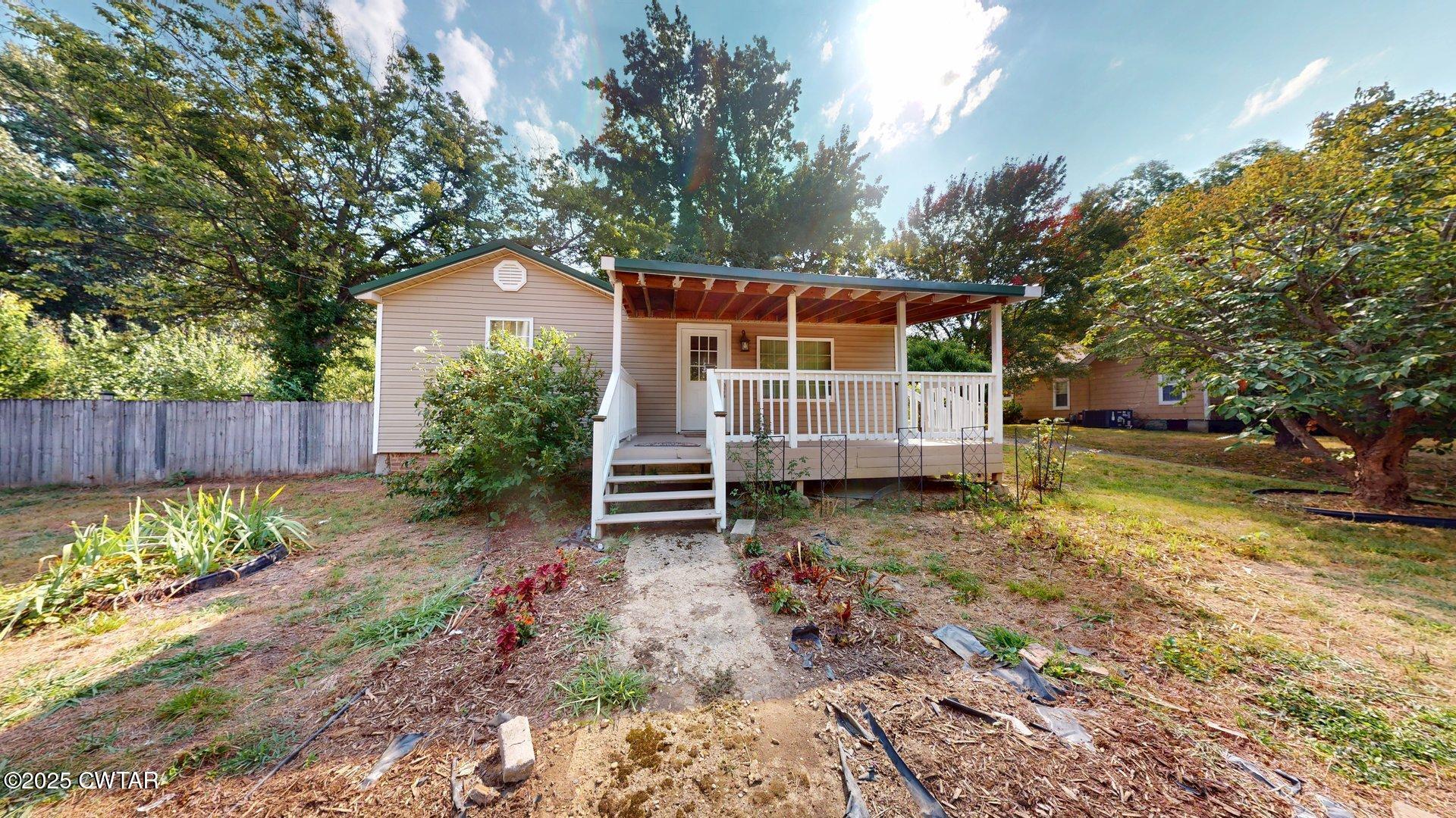 a view of a wooden house with a yard