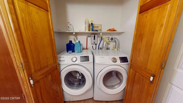 a view of storage and utility room with washer and dryer