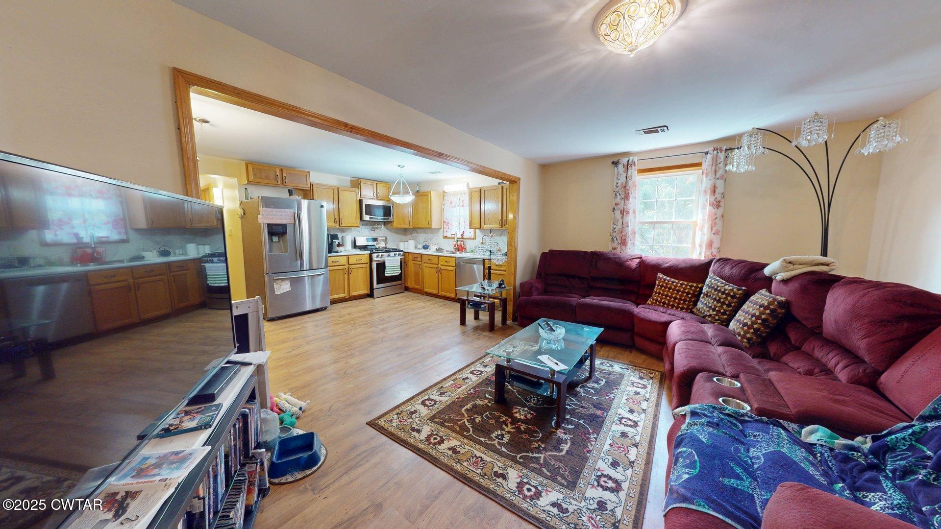 310 North Grayson Street Newbern, TN 38059 - Photo 6 of 22 a living room with furniture and a flat screen tv