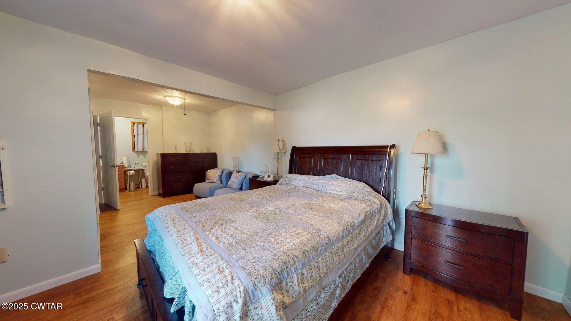 310 North Grayson Street Newbern, TN 38059 - Photo 7 of 22 a bedroom with bed and wooden floor