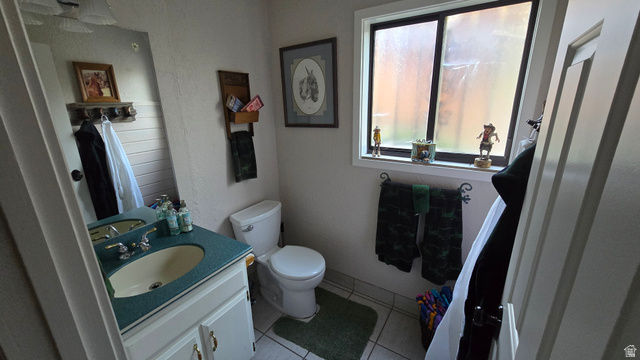 11077 Susan Drive Sandy, UT 84092 - Photo 19 of 20 Half bathroom featuring vanity and light tile patterned flooring