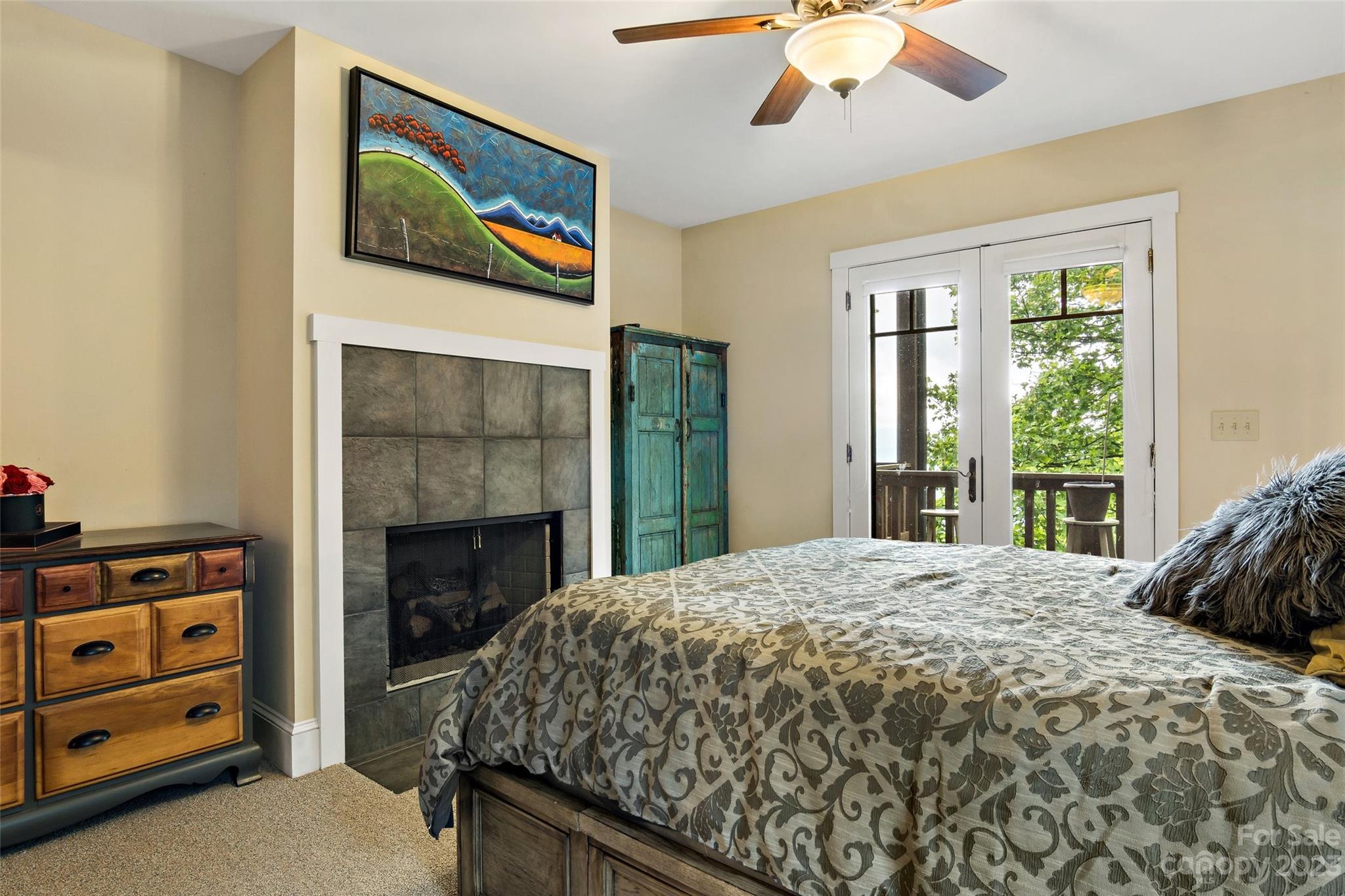 610 Creston Drive Black Mountain, NC 28711 - Photo 23 of 47 a bedroom with a bed and a fireplace