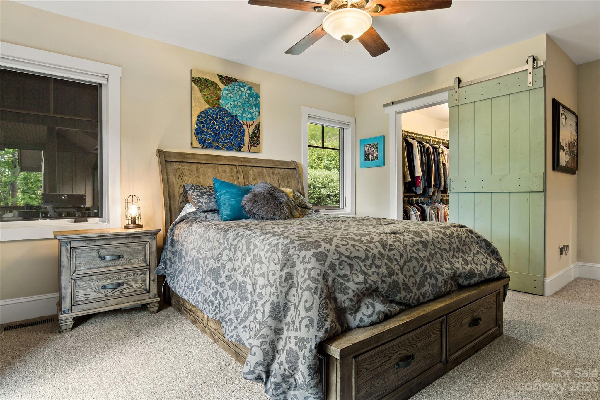 610 Creston Drive Black Mountain, NC 28711 - Photo 24 of 47 a bedroom with a large bed and a chandelier