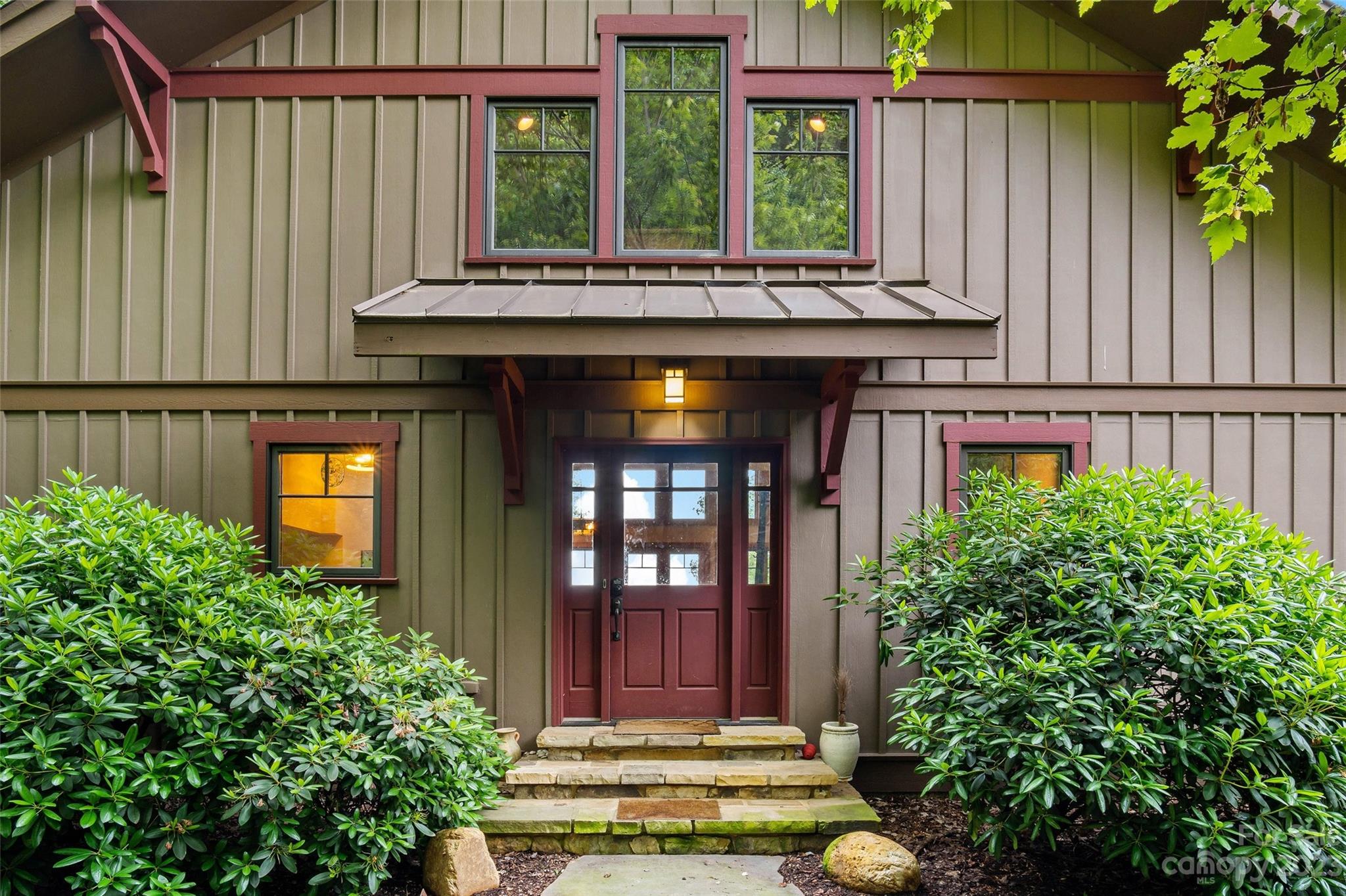 610 Creston Drive Black Mountain, NC 28711 - Photo 4 of 47 front view of a house with large windows and a potted plants