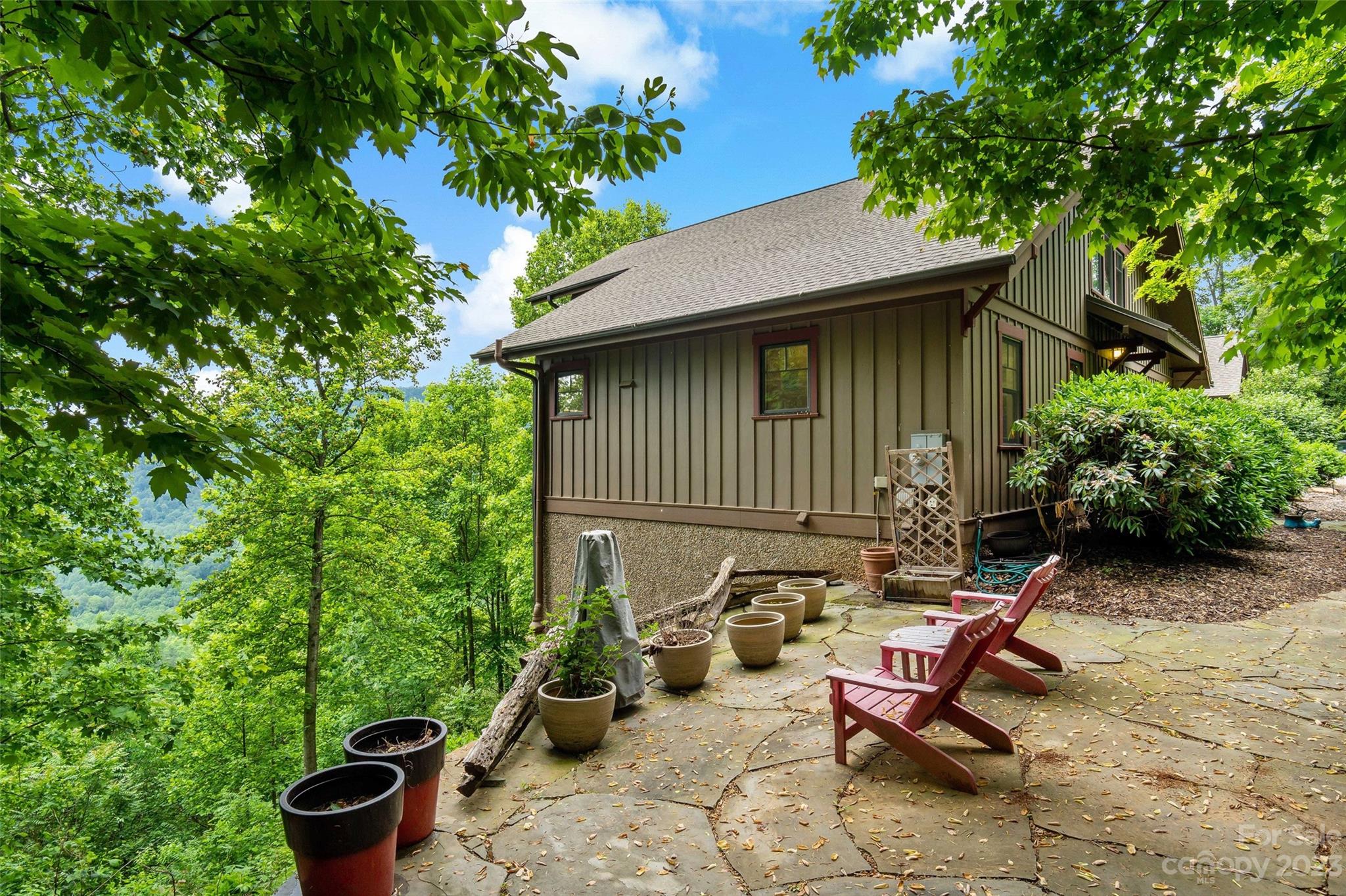 610 Creston Drive Black Mountain, NC 28711 - Photo 5 of 47 a view of a chair and table in backyard
