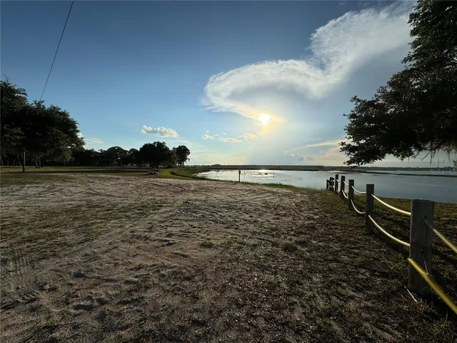 a view of a yard with large trees